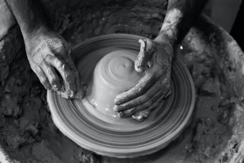 Hands working on a pottery wheel