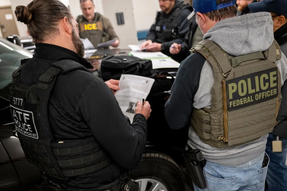 Federal law enforcement agents in meeting
